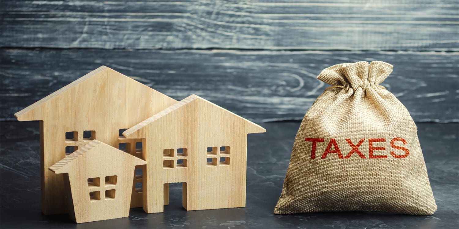 Conceptual image of property taxes dominating house